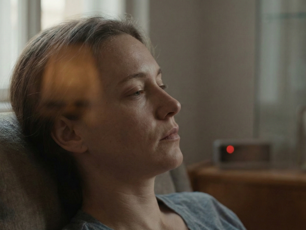 A person sitting quietly with a tired, reflective expression, representing mental exhaustion and decision fatigue in modern life.